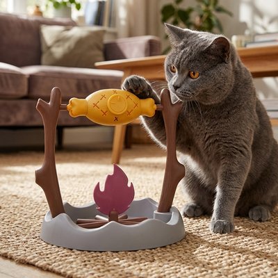 chat qui pose la patte sur le poisson de son jouet pour chat